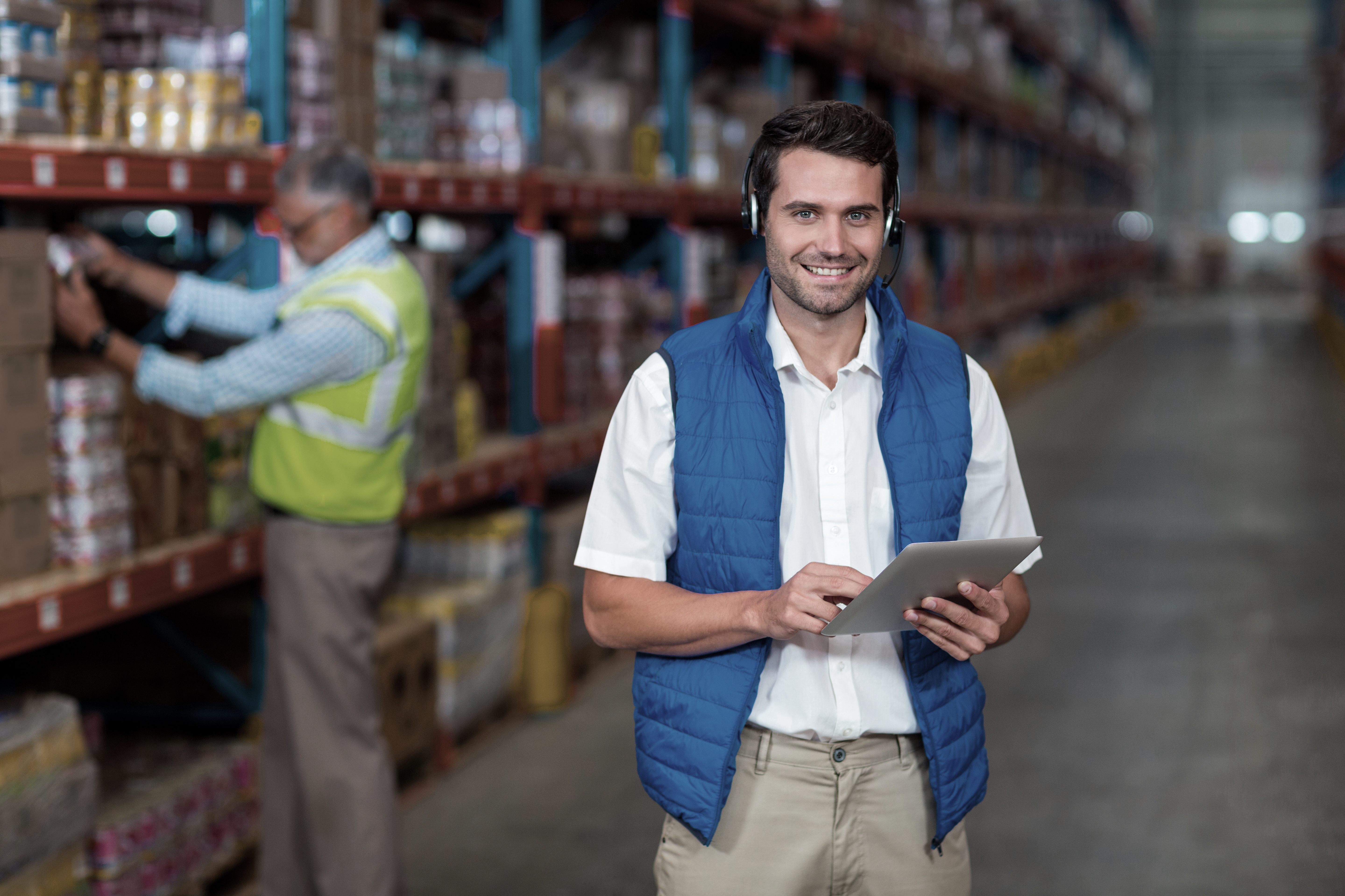 Standing Worker Smiling At Camera While Holding Digital Tablet